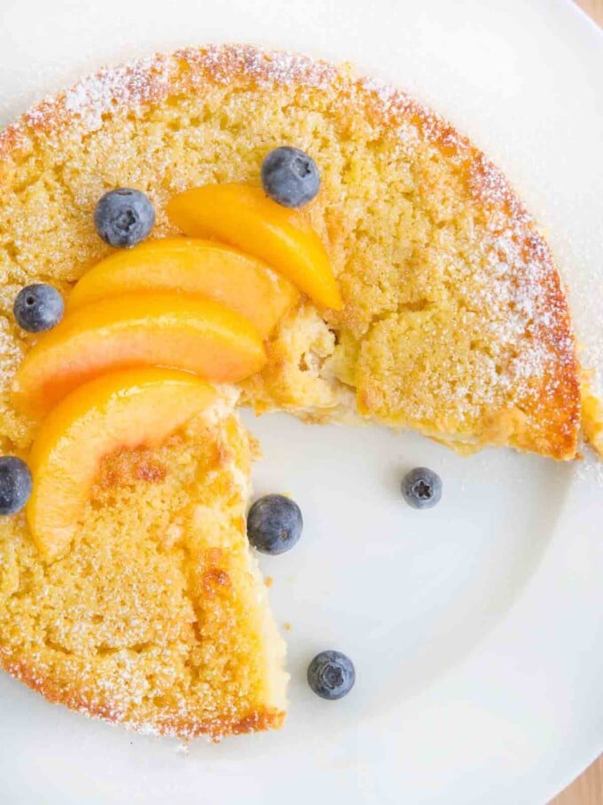 overhead view of peaches and cream breakfast cake with a slice cut out