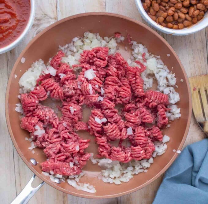 ground beef added to pan with sauteed onions