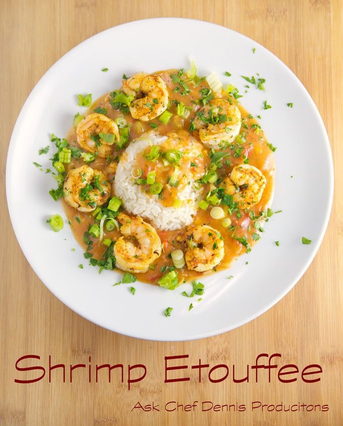 shrimp etouffee with white rice on a white plate sitting on a cutting board
