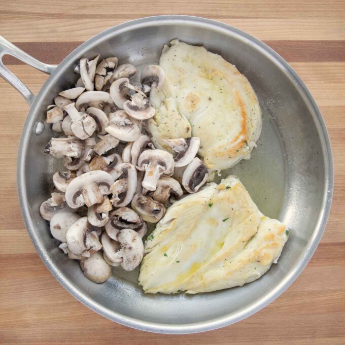 sauteed chicken breast with mushrooms in a saute pan