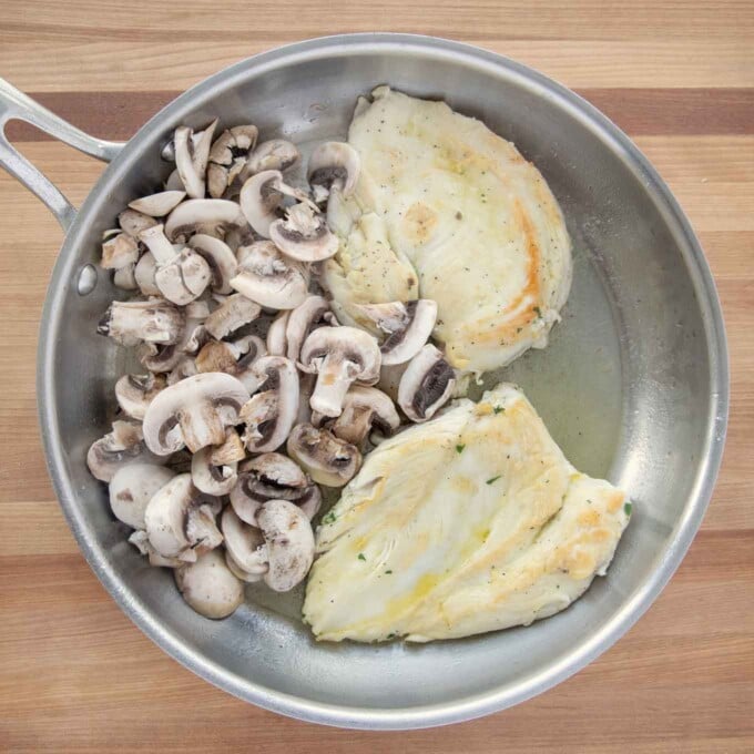 sauteed chicken breast with mushrooms in a saute pan