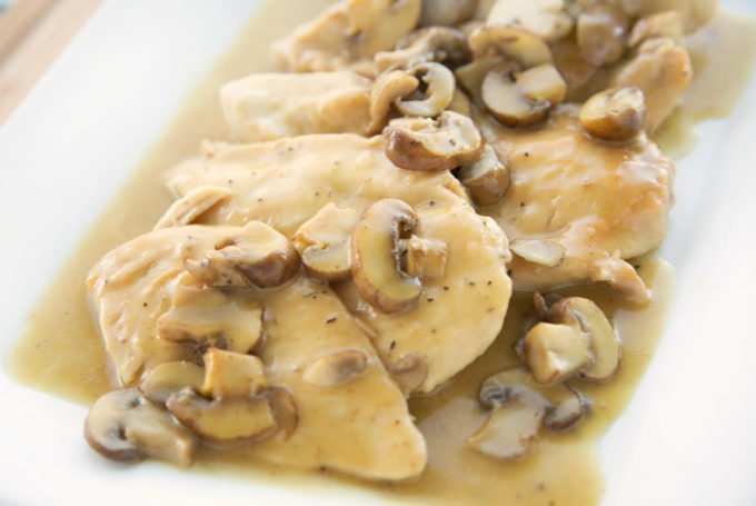 Chicken Marsala with mushrooms on a white platter