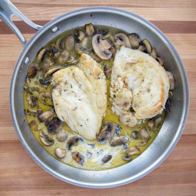 stock and cream added to the chicken marsala in a saute pan