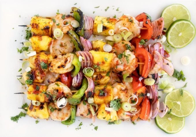 Grilled Shrimp and pineapple skewers on a white platter