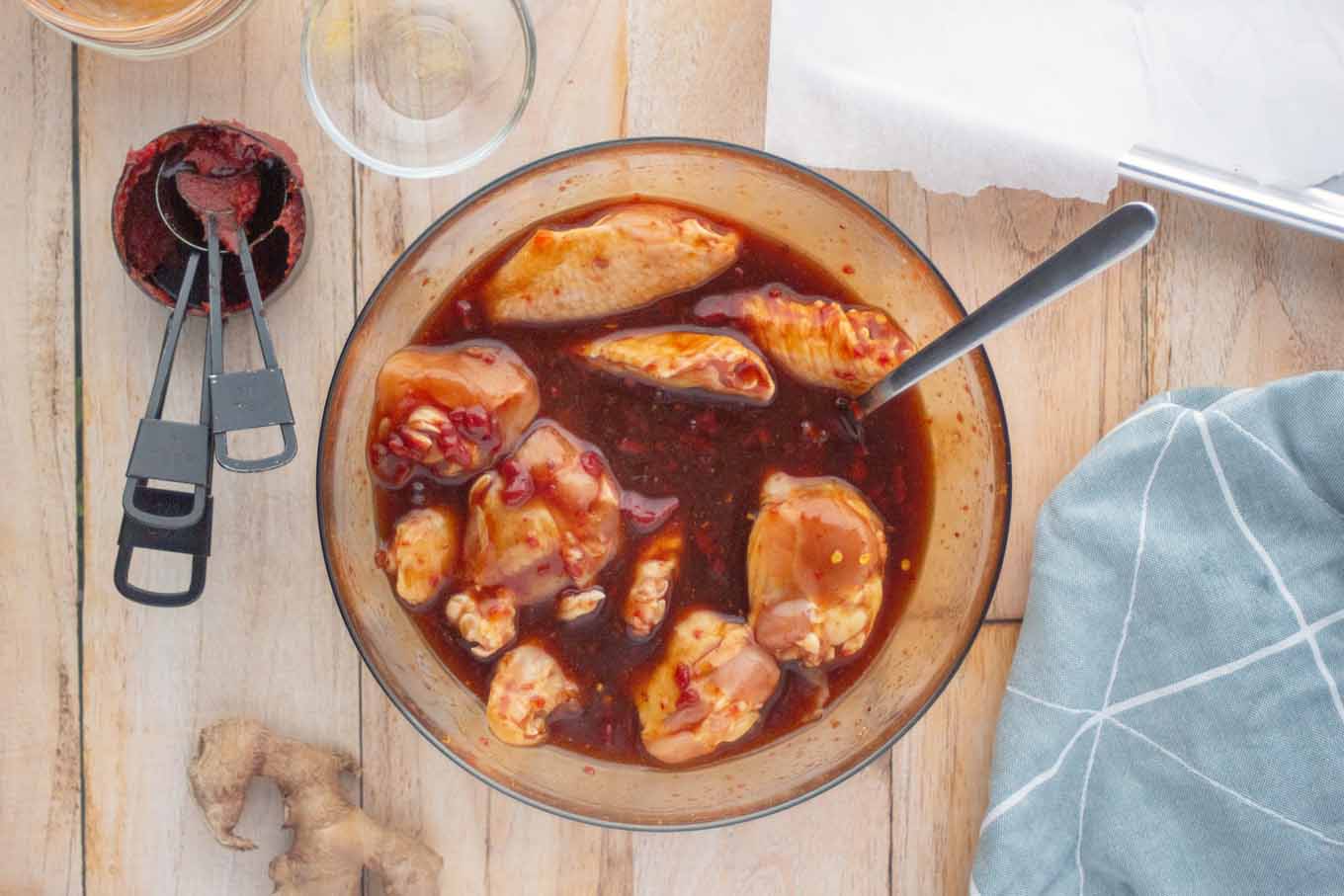 chicken wings in the bowl of marinade