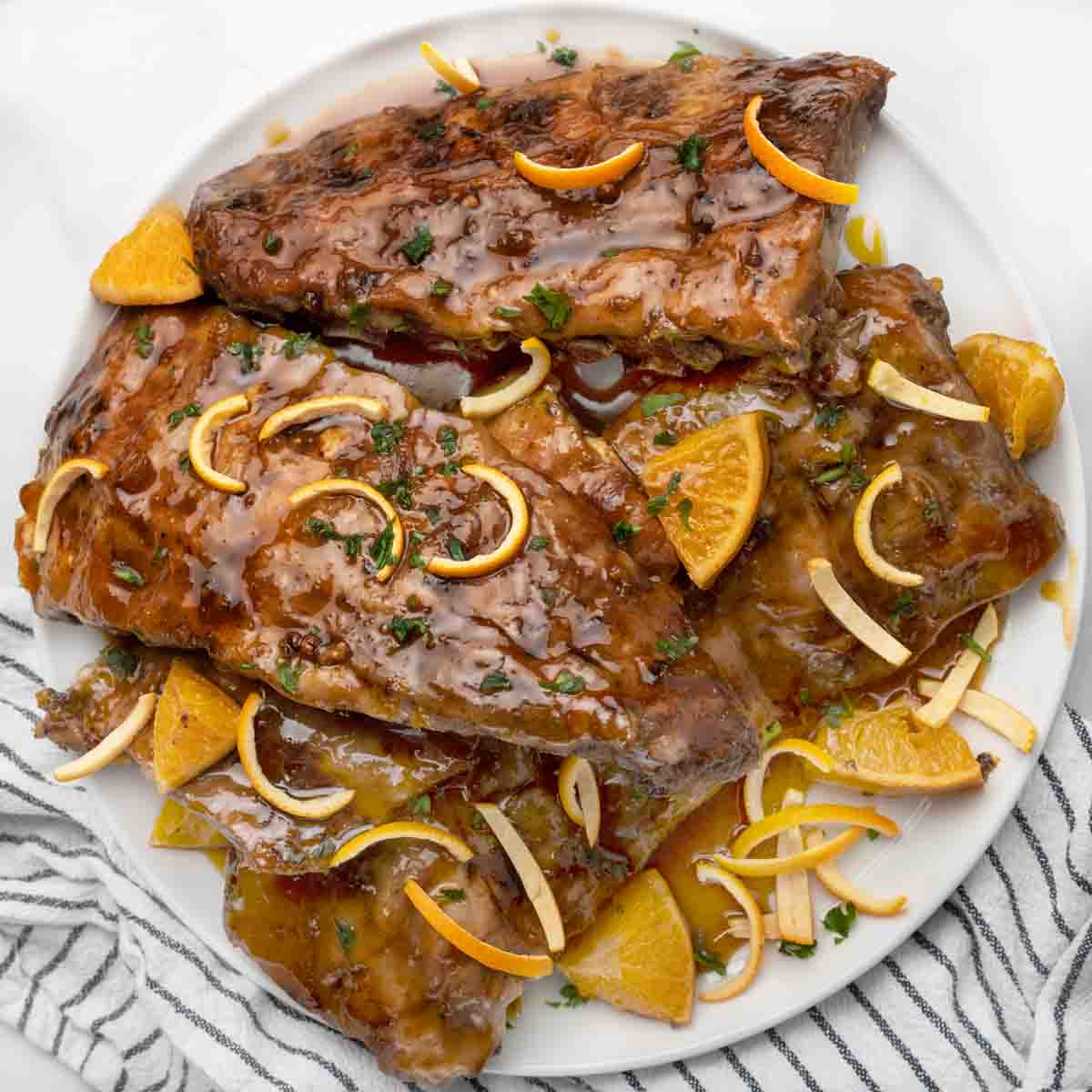 racks of Chinese sticky ribs on a white platter