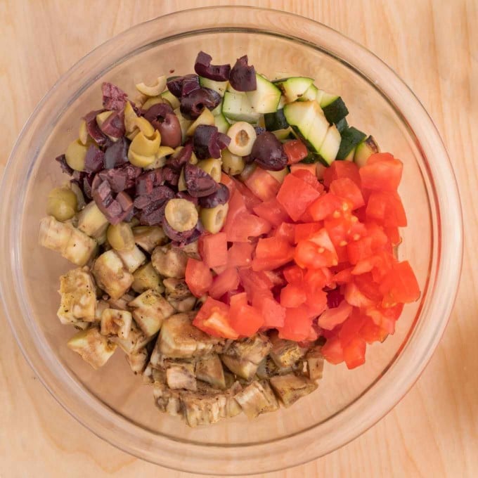 diced vegetables and chopped olives in a glass bowl