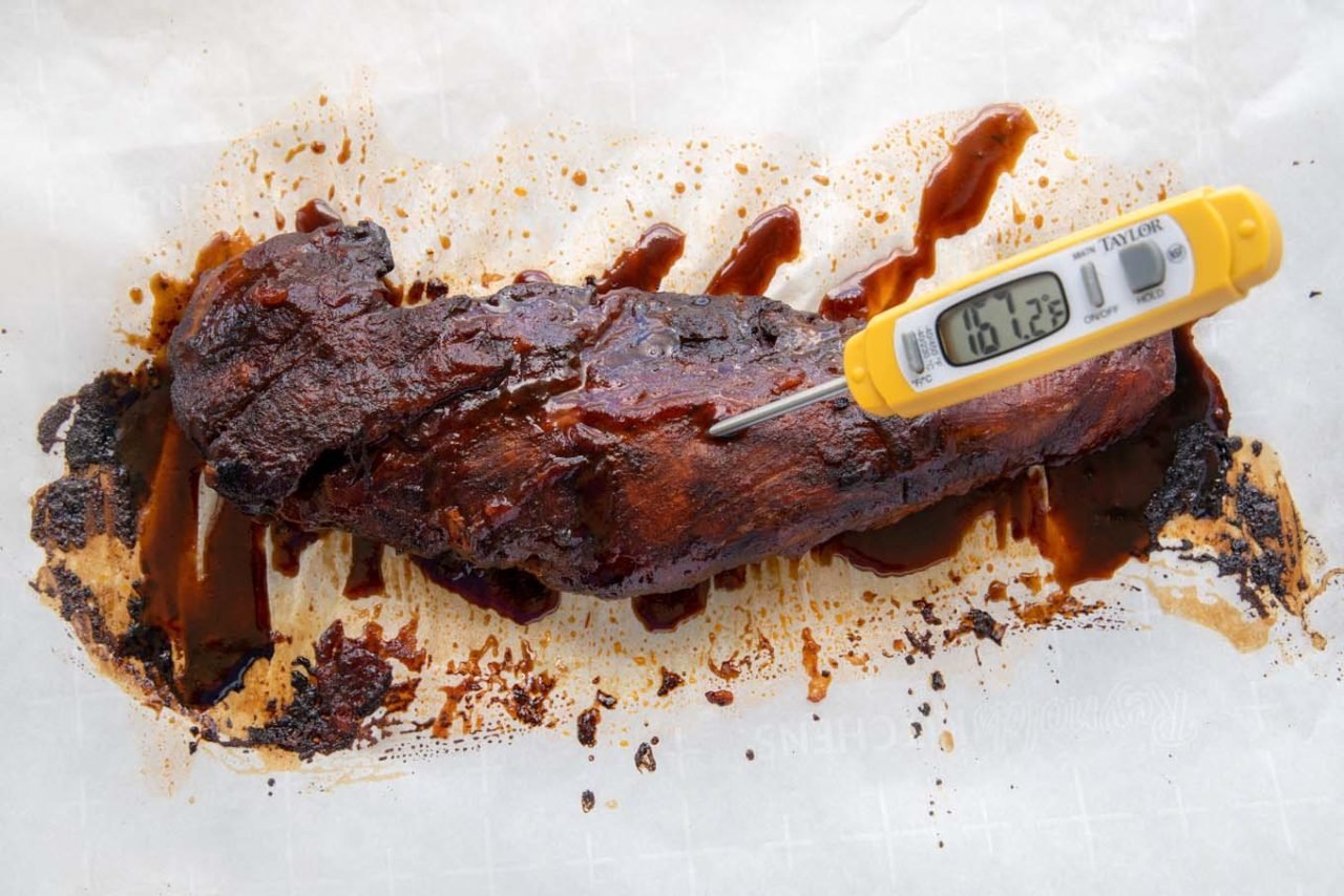 cooked barbecued pork tenderloin with meat thermometer