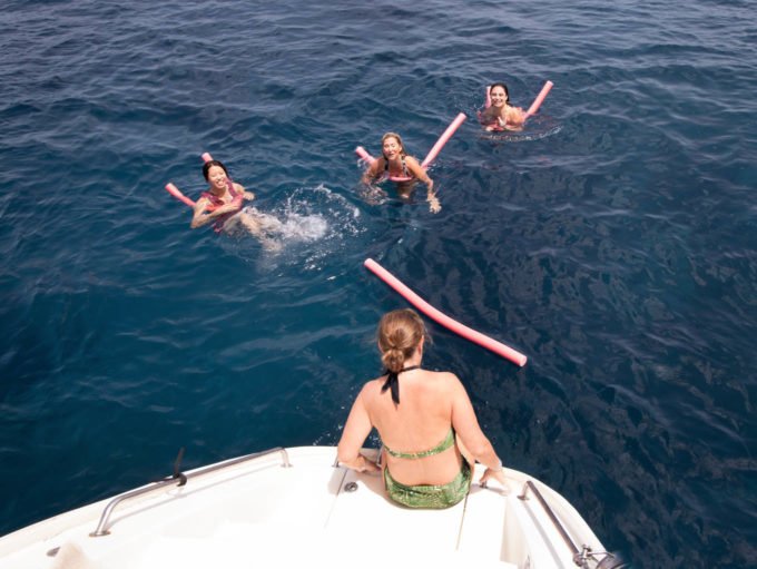 swimmers in the Aegean sea with Lisa watching from the boat