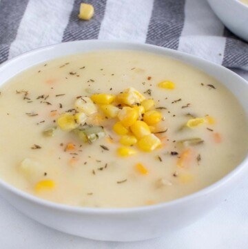 close up of corn chowder in a white bowl