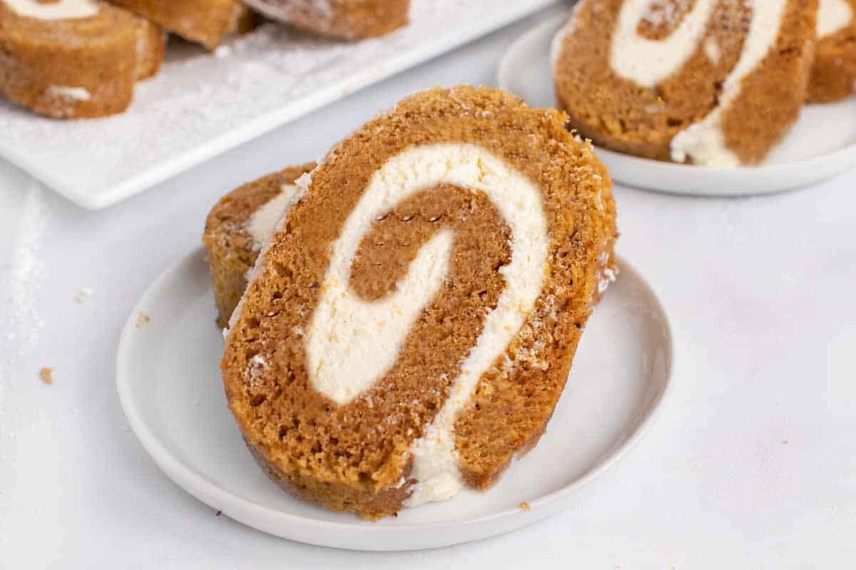 two slices of pumpkin roll on a white plate