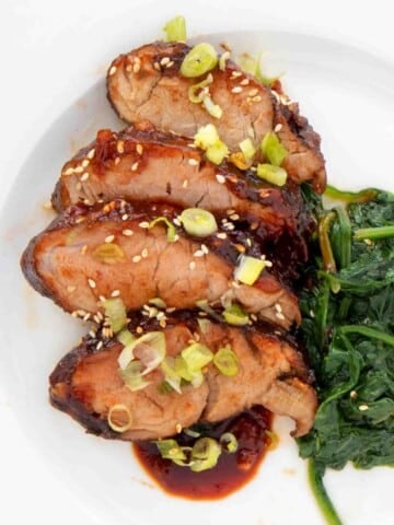 Korean Pork Barbecue and spinach on a white plate