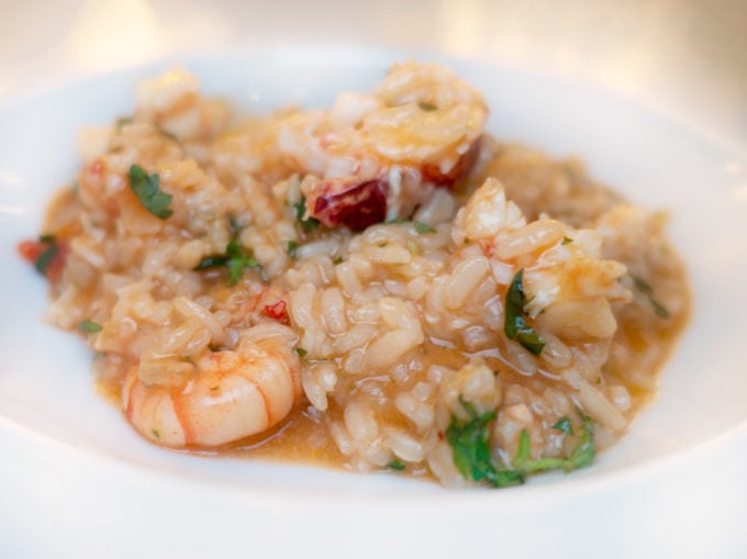 white bowl with seafood and rice, know as a rice bowl in Lisbon