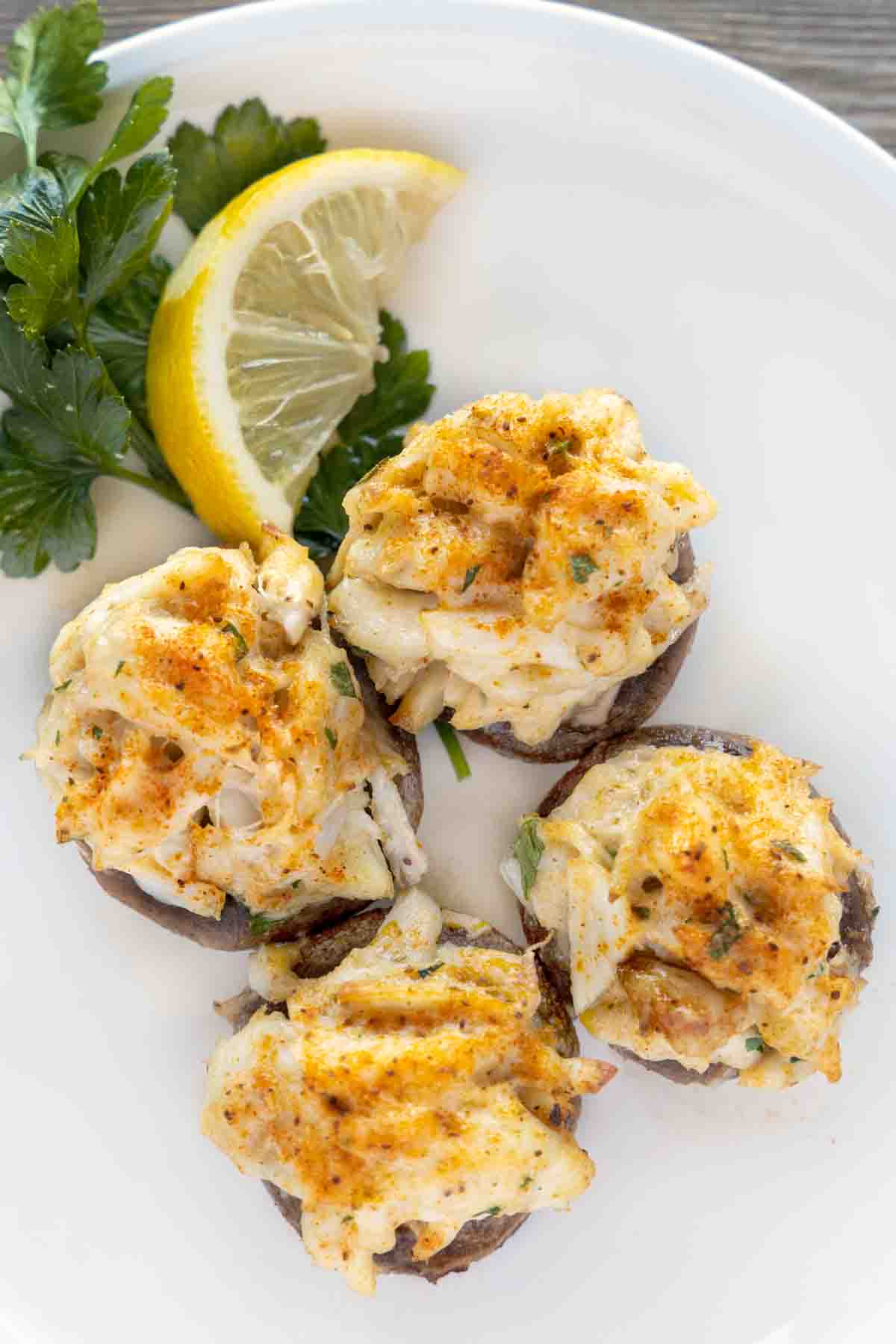 crab stuffed mushrooms on a white plate