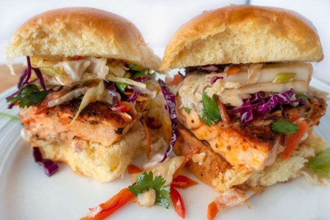 2 blackened salmon sliders with an Asian Slaw on a white plate