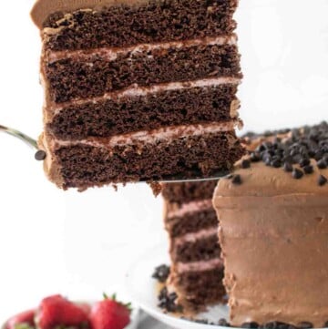 slice of cake on a spatula being taken out of the whole cake