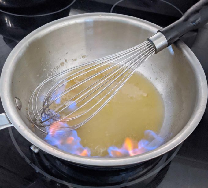 flambeed margarita sauce in a small saucepan with a whisk