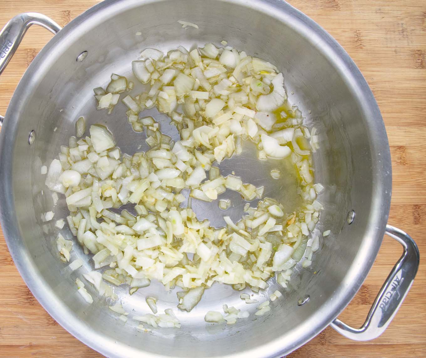 sauteing onions in a large sauce pan