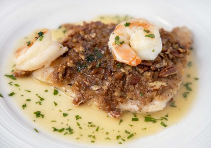 pecan snapper with shrimp on a white plate with margarita sauce