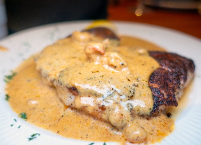 blackened grouper with crawfish in a cajun cream sauce