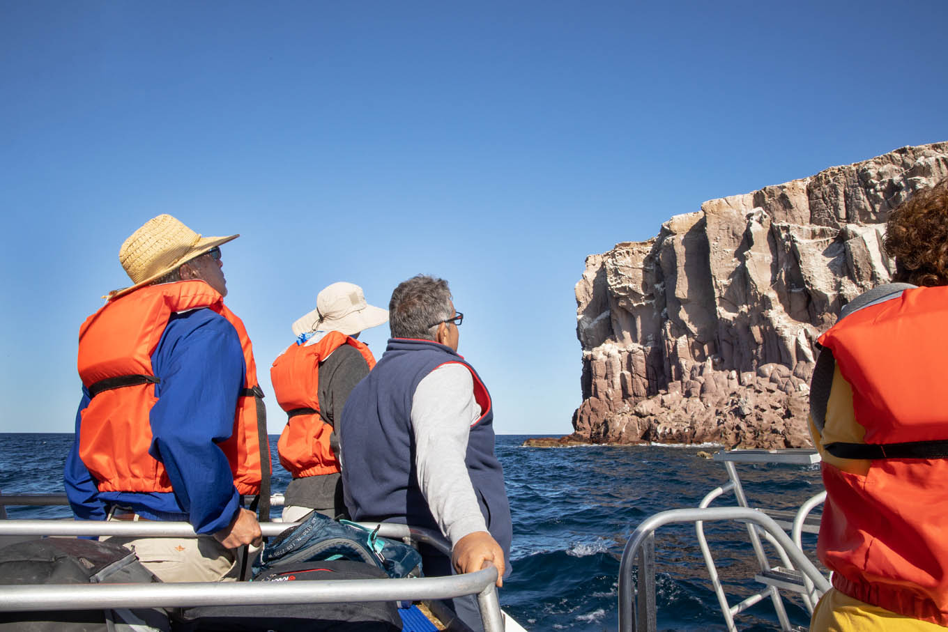 people on board a skiff in the sea of cortez.