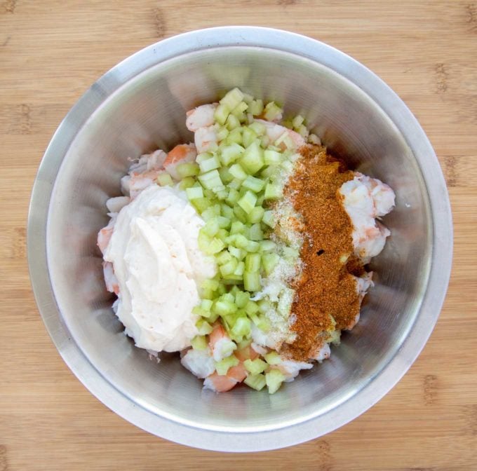 shrimp salad ingredients in a stainless steel bowl before mixing