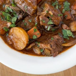 overhead shot of half a white bowl full of Guinness beef stew