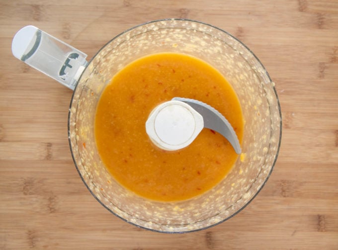 Mango bourbon glaze pureed in a bowl of a food processor