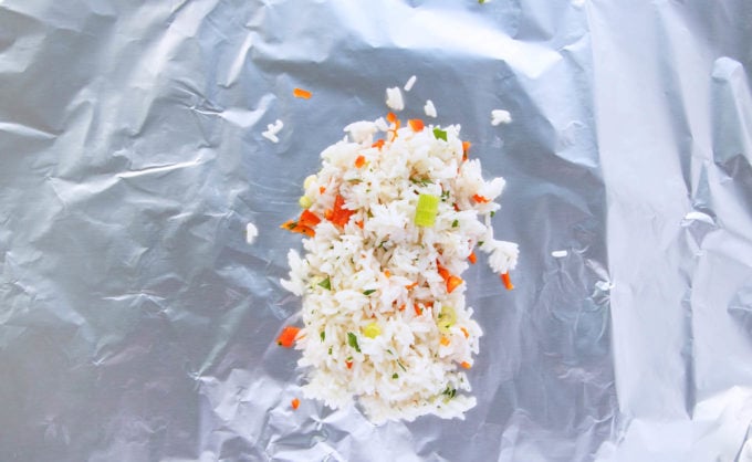 seasoned rice on a sheet of foil