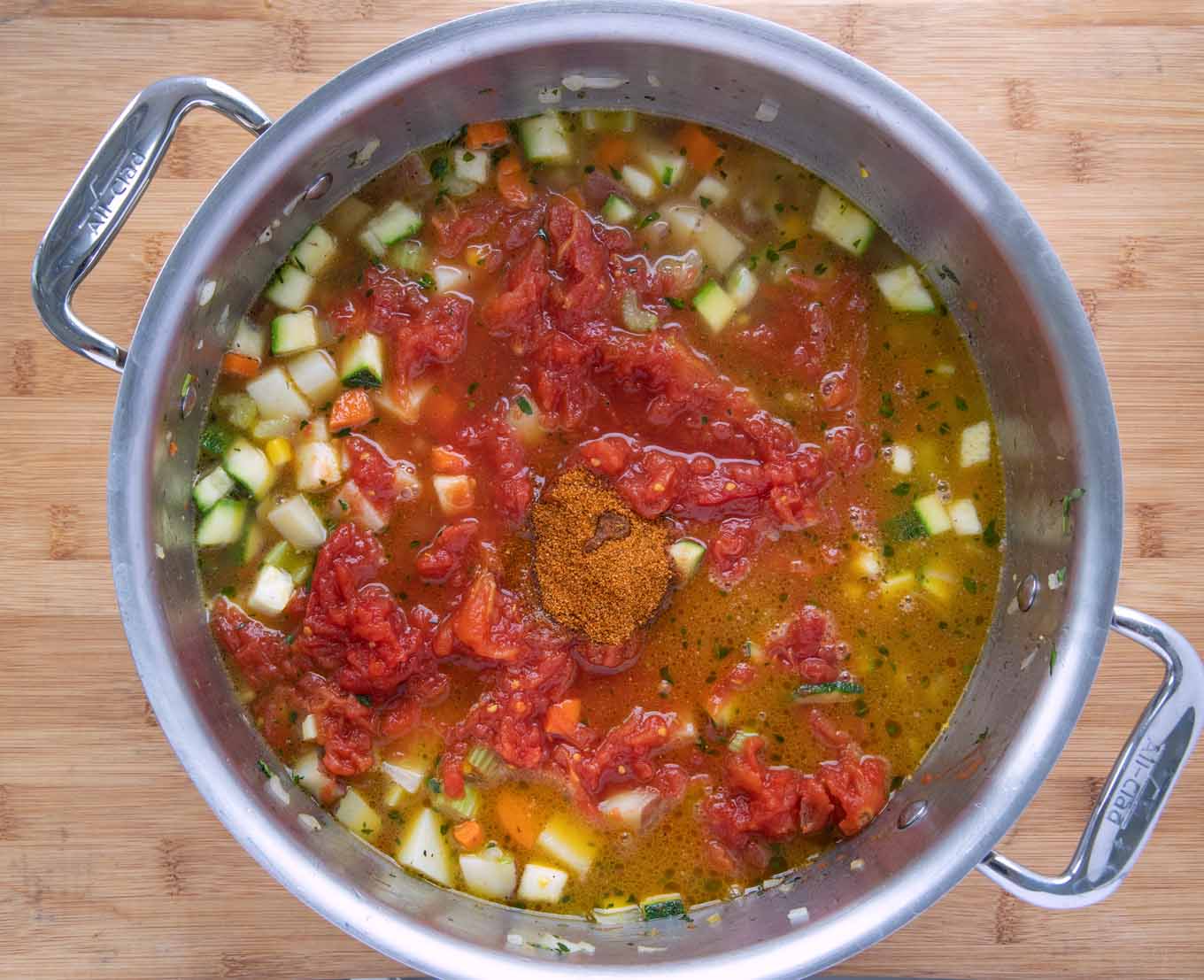 Large pot with tomatoes and water added to the pot