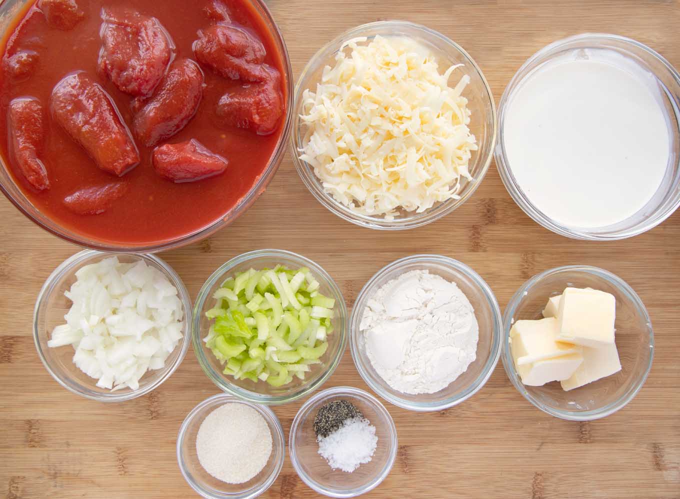 ingredients to make recipe in glass bowls on a wooden cutting board.