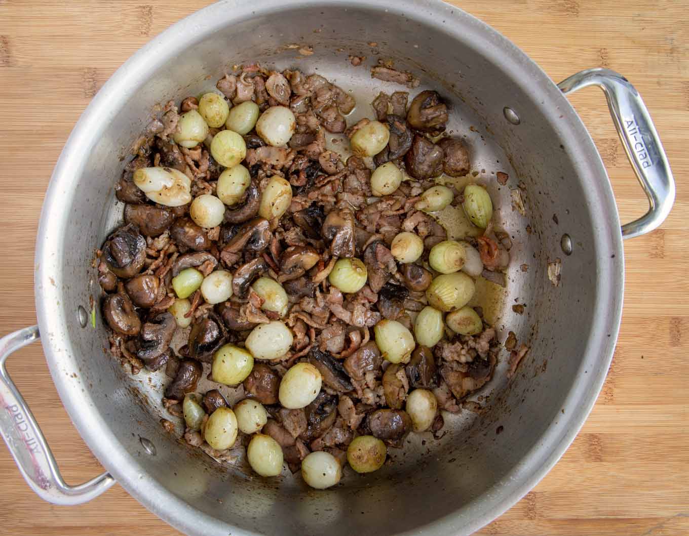 large pot with bacon, onions, mushrooms for beef stew