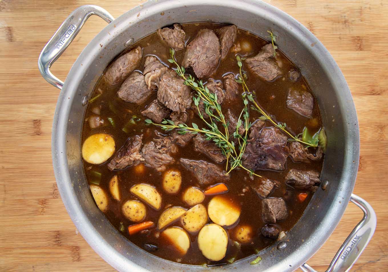 large pot with stew ingredients ready to cook