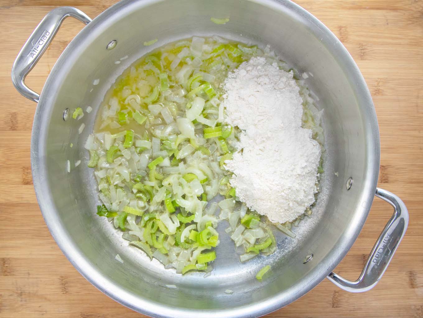 Sauteed chopped onions and celery in a pot with a cup of flour.