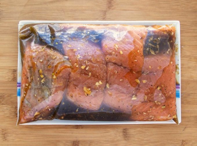 salmon marinating in a ziplock bag