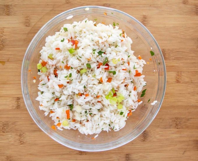 seasoned jasmine rice in glass bowl on wooden cutting board