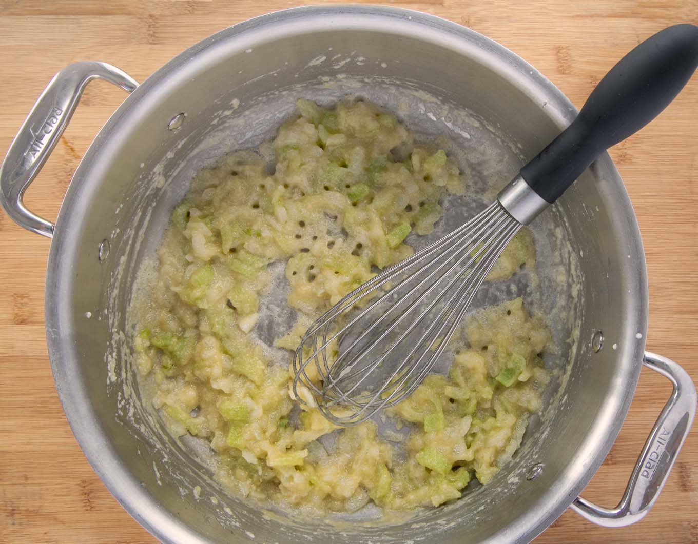 roux with a wire whip in a large pot.