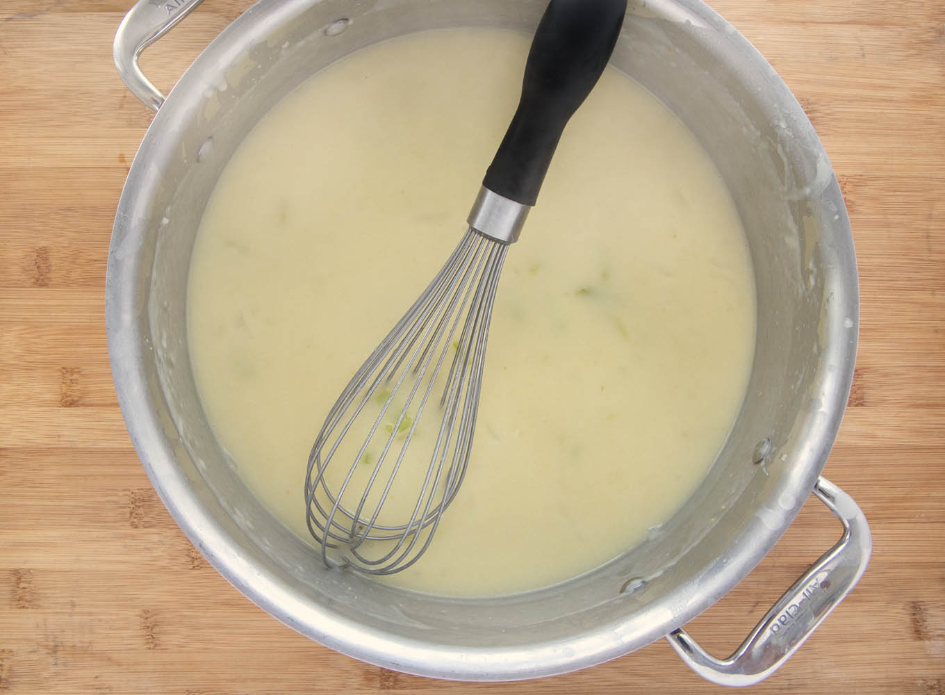 Veloute in a large pot with a wire whisk.