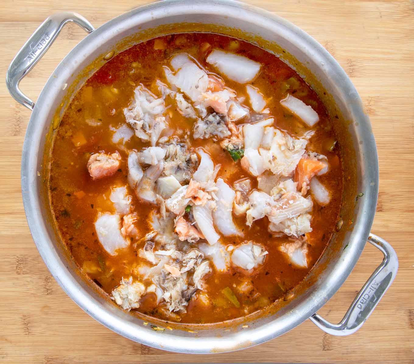 seafood added to large pot of soup