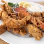 fried lobster tails on a white plate