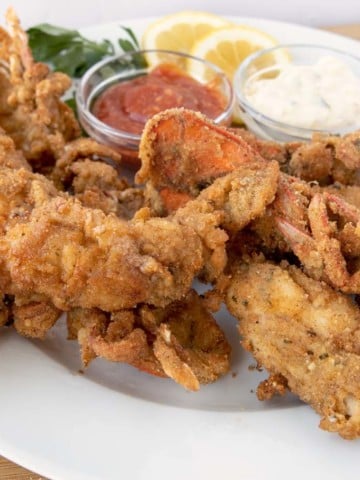fried lobster tails on a white plate