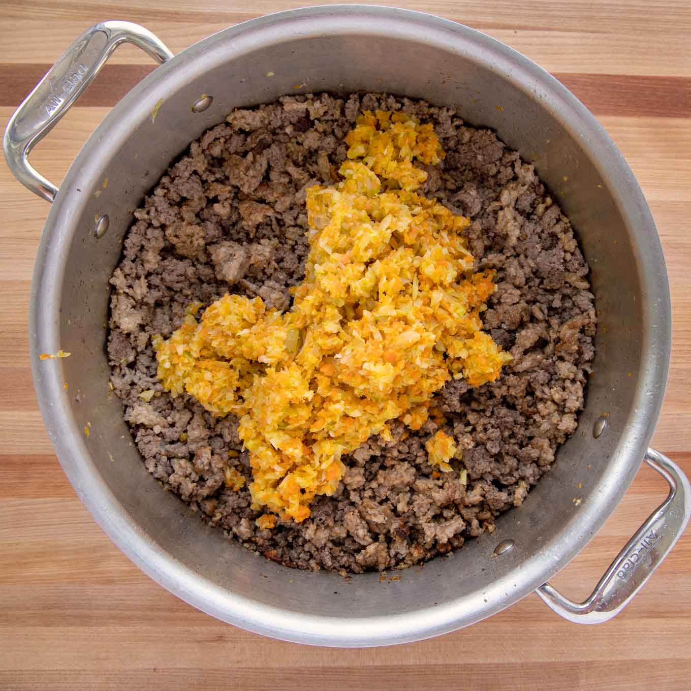 Soffritto and meat in a large pot.