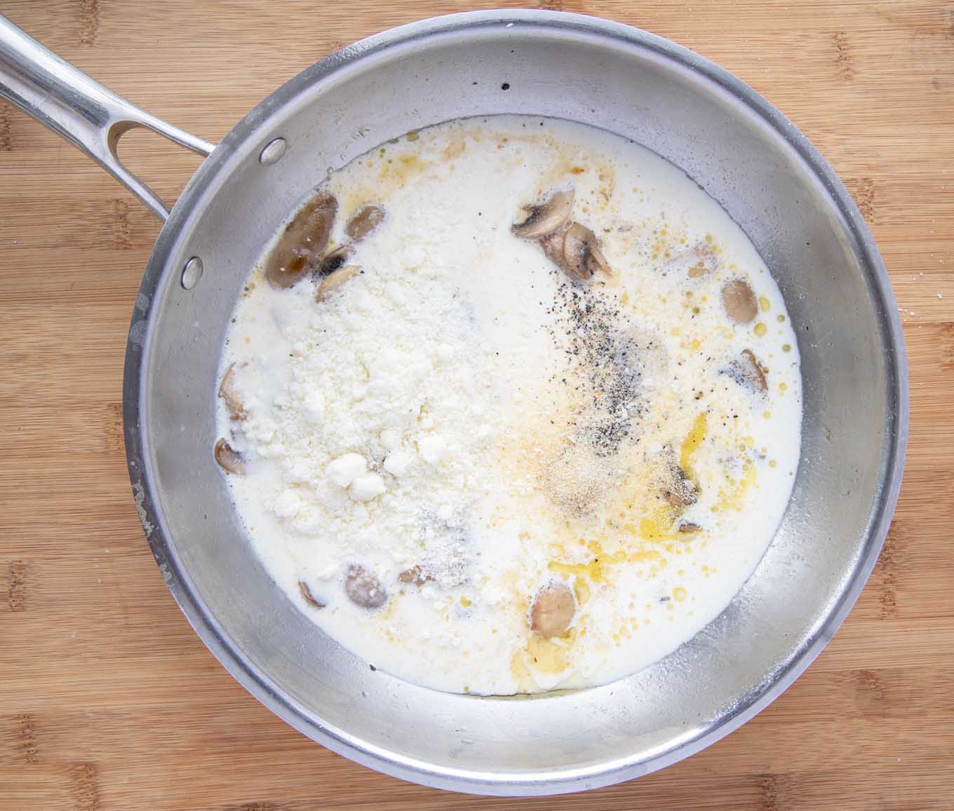 cream, romano cheese and spices with the mushrooms in a saute pan.