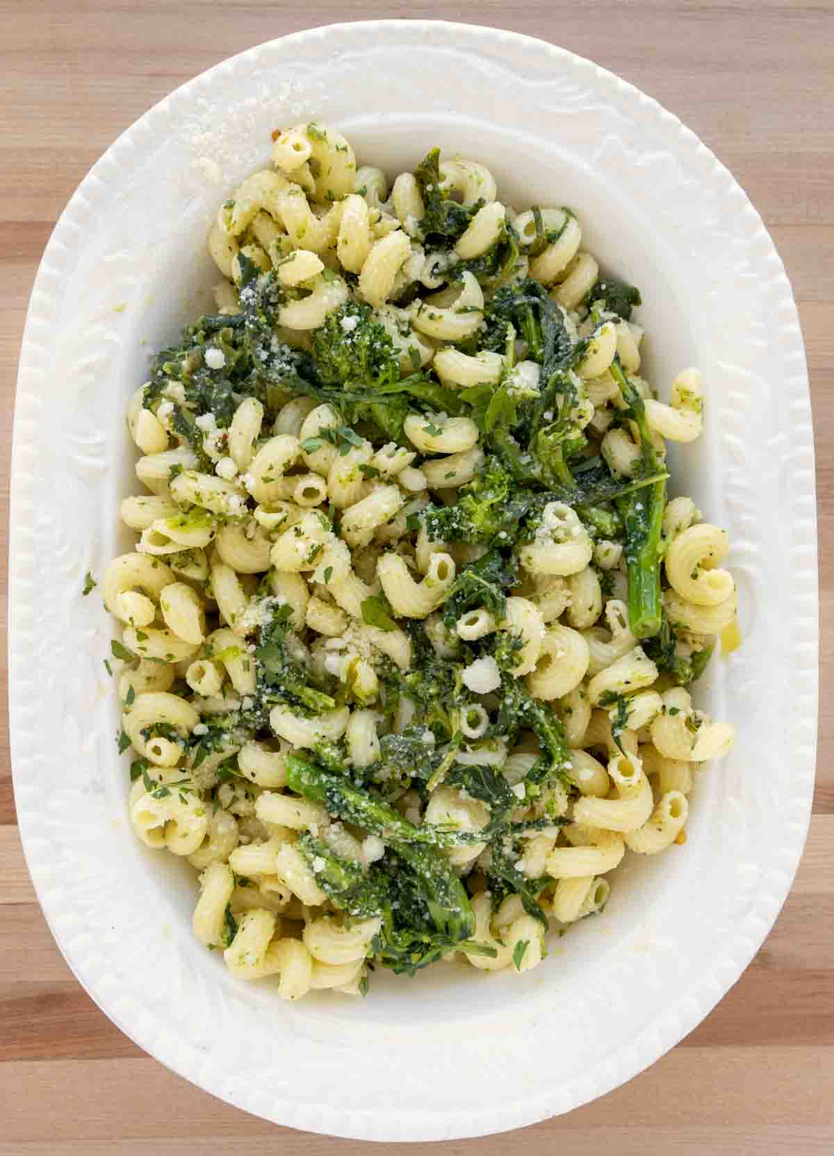 overhead shot ofPasta Aglio e Olio with Broccoli Rabe in a white oval bowl