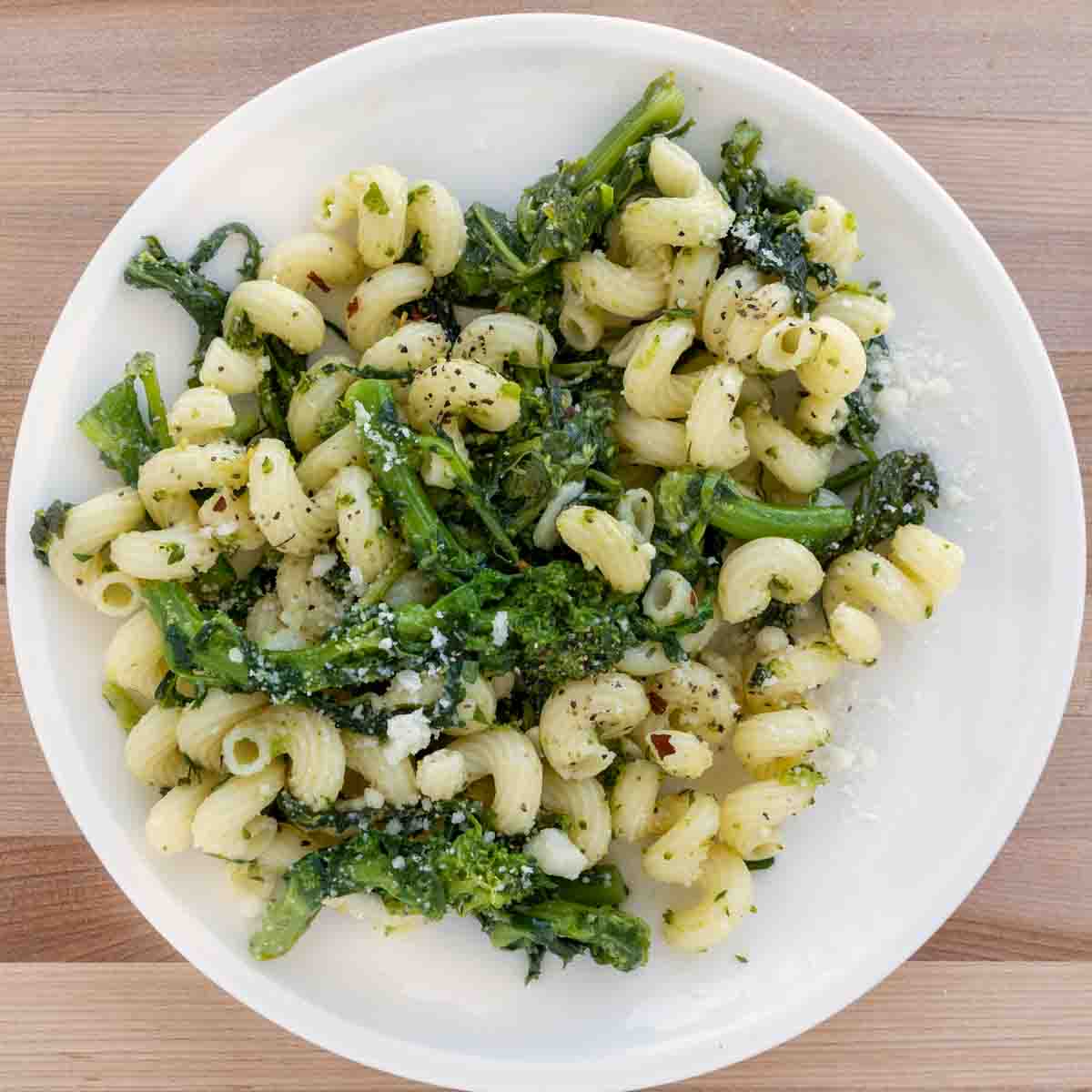 overhead image of Pasta Aglio e Olio with Broccoli Rabe on a white plate.