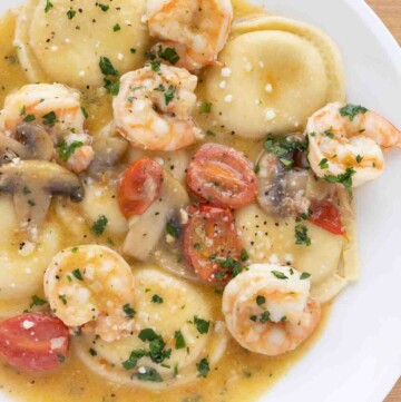 overhead view of ravioli shrimp scampi on a white plate