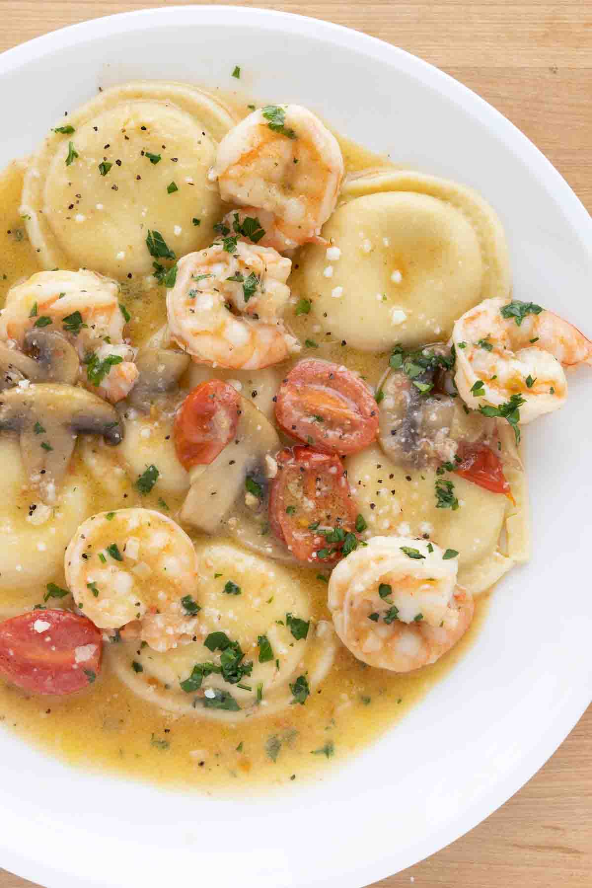 overhead view of ravioli shrimp scampi on a white plate