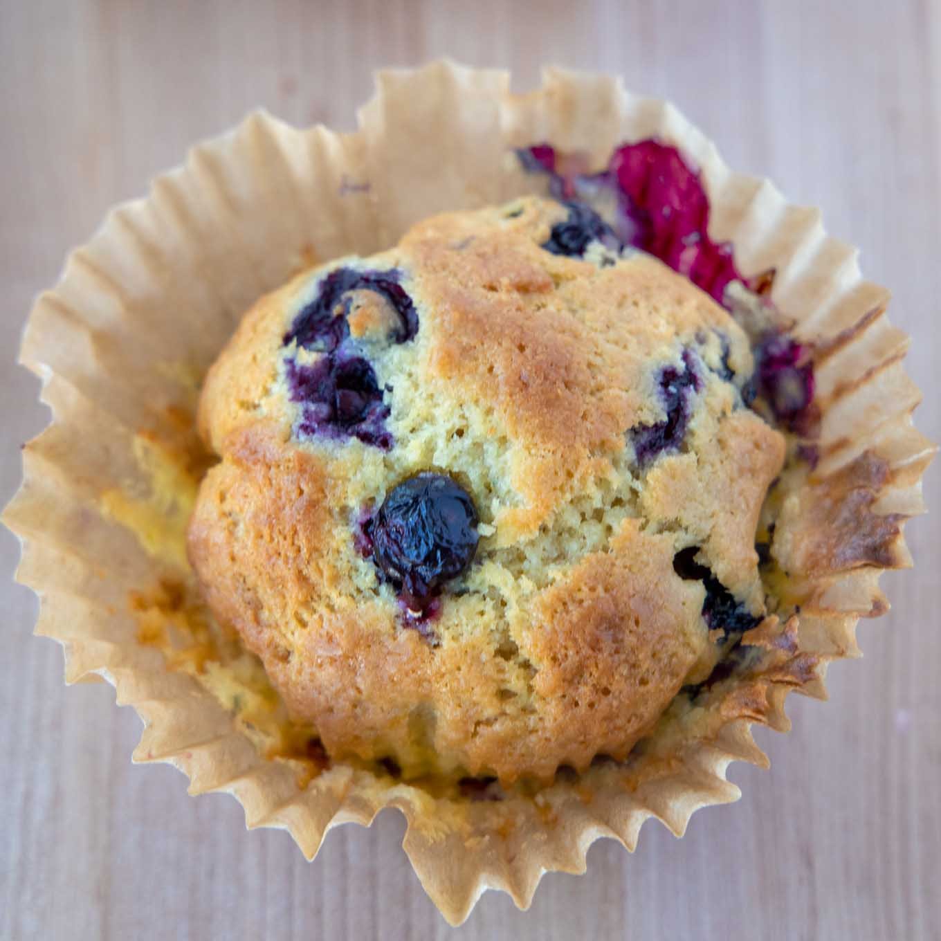 Blueberry Muffin with paper pulled away from muffin