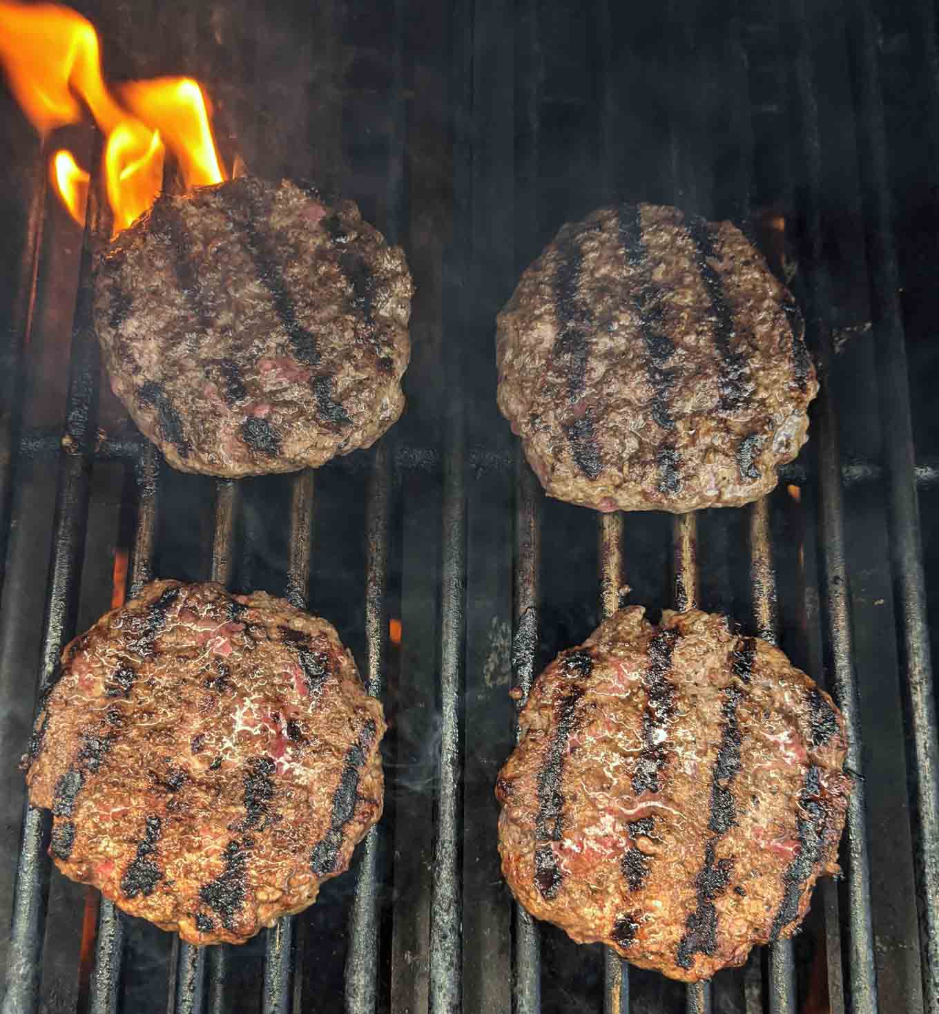 burgers cooking on the grill