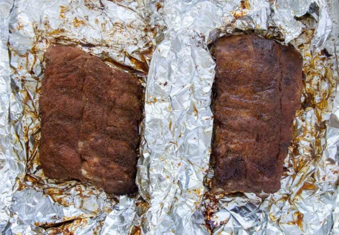 2 unwrapped half racks of grilled baby back ribs